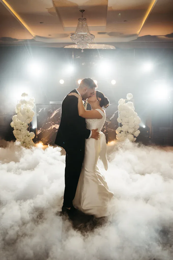 Couple in their first dance on a low cloud of dry ice